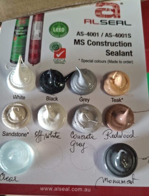 A collection of color samples displayed on a piece of paper, featuring various shades such as white, black, grey, teak, sandstone, off-white, concrete, monument and redwood. The background includes branding and information related to ALSEAL MS Construction Sealant.